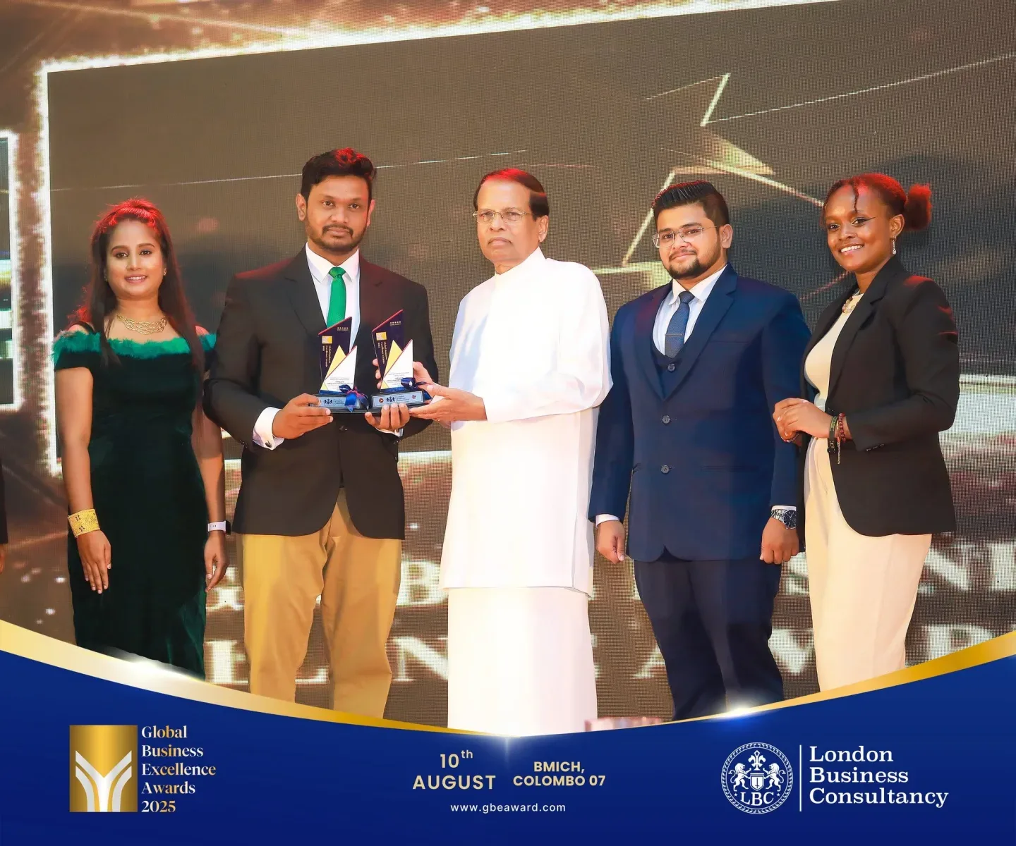Global Business Excellence Awards recipients and programme representatives during a stage presentation