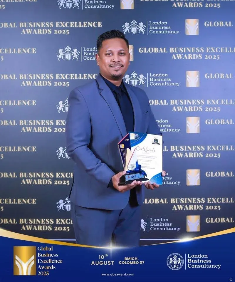 Global Business Excellence Awards recipient holding a trophy and certificate