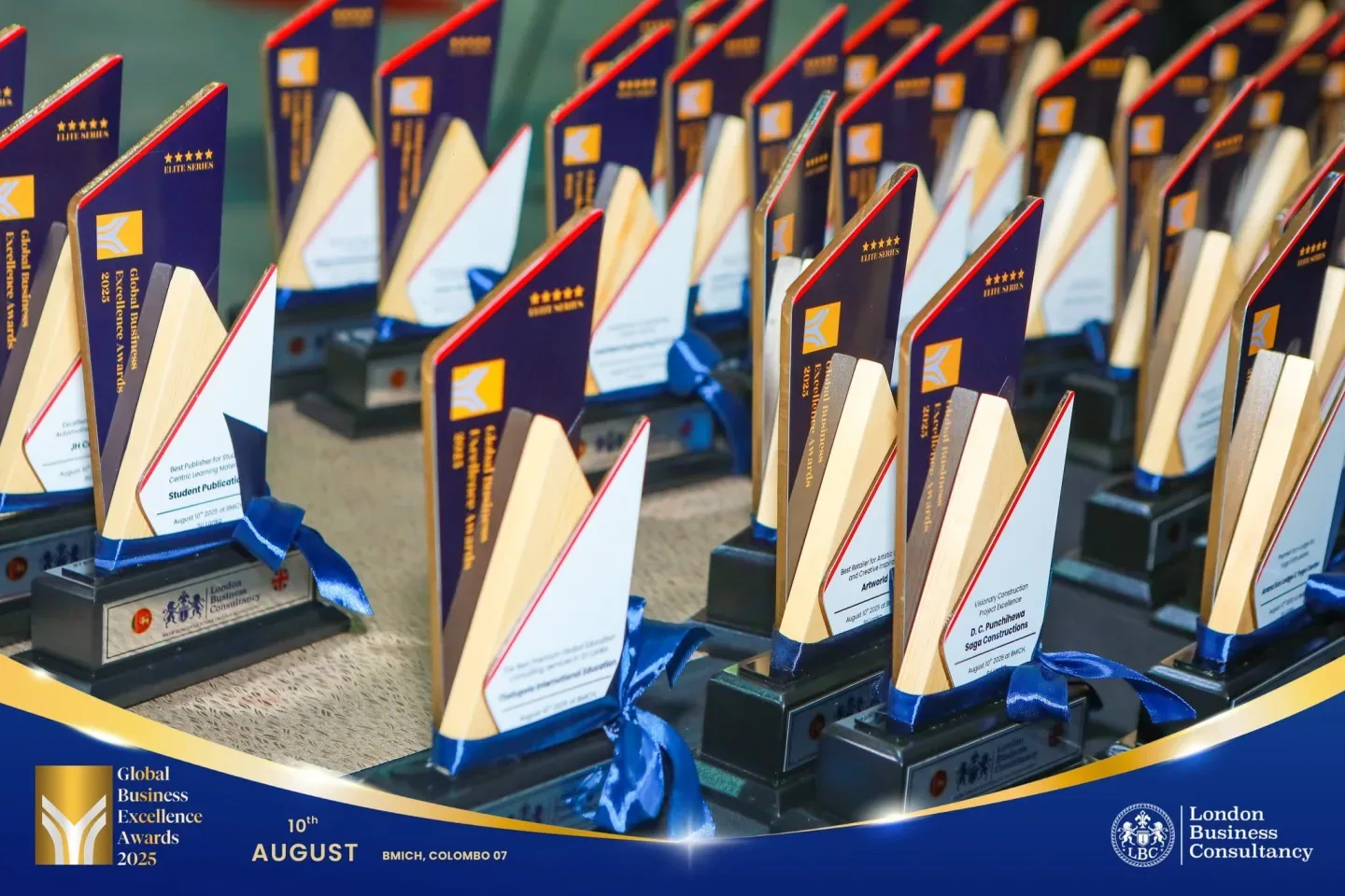 Rows of trophies prepared for a Global Business Excellence Awards ceremony