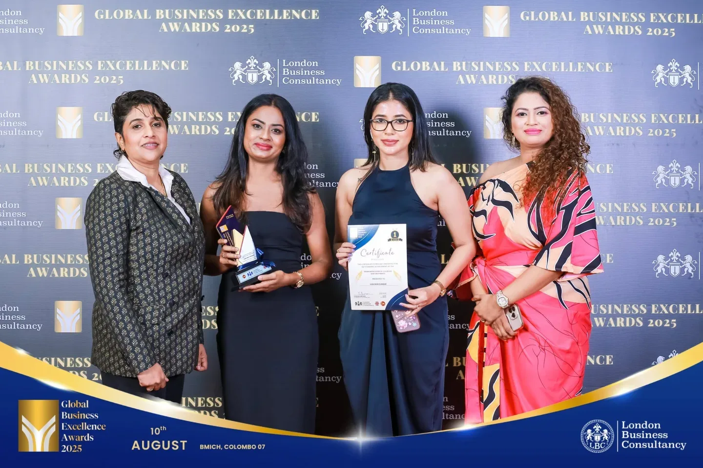 Women recipients and guests with a Global Business Excellence Award and certificate